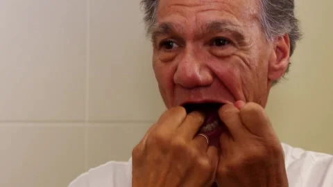 Senior man flossing his teeth Stock Footage 231491241