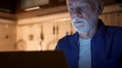 Senior man freelancer using laptop at night from home-office. Overworked Stock-Footage 93906859