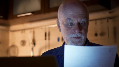 Senior man freelancer using laptop at night from home office. Overworked Stock Footage 99155082