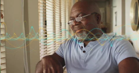 Senior man gazing at computer activating audio waveform visualization tech and Video stock 314474828