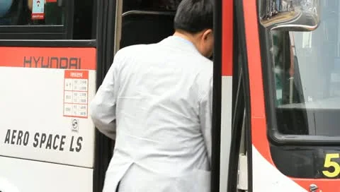 Senior man getting on bus Stock Footage 11133220