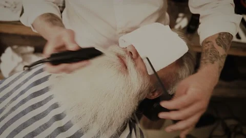 Senior man getting styling and trimming of his beard in the barbershop Stock-Footage 233627096