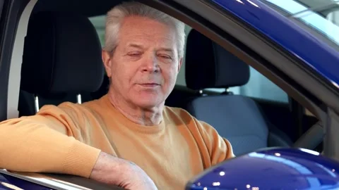 Senior man gives a thumbs up while looking into the side mirror of the car Stock Footage 311941695