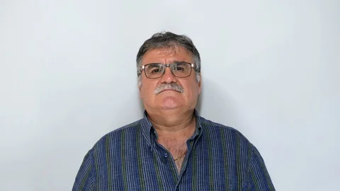 Senior man with glasses looking at camera isolated on white background. Stock Footage 115441599