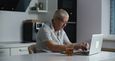 Senior man with glasses using laptop computer for shopping online and paying Stock Footage 146612203