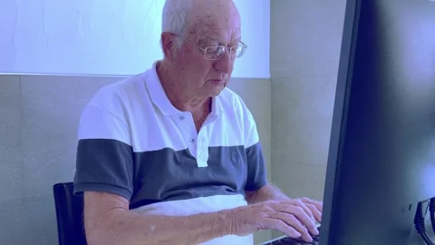 Senior man with good computer skills writing on computer keyboard Stock Footage 232169554