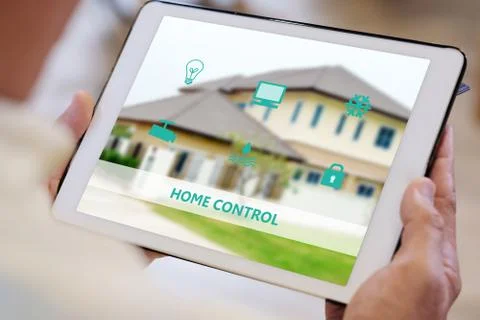 Senior man hand using digital tablet with smart home control icon on screen w Stock Photos