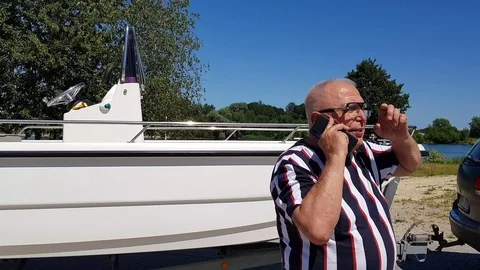 Senior man has conversation on cellphone at cater on piers Stock Footage 112395233