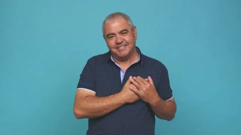 Senior man has friendly expression, pressing palm to chest love concept Stock Footage 144217632