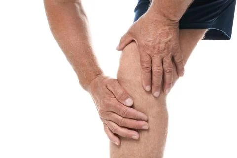 Senior man having knee problems on white background, closeup Stock Photos
