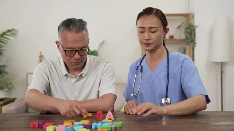 Senior man having treatment with bricks with aide Stock Footage 196200046