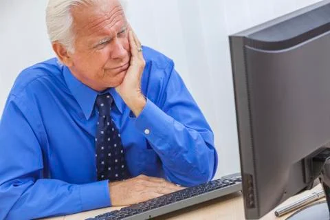 Senior man having trouble using computer Stock Photos