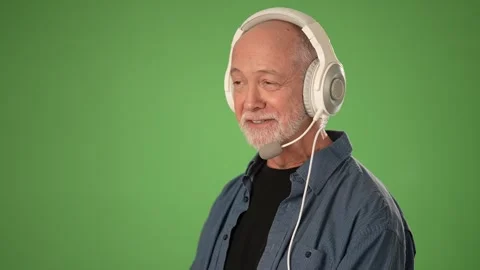 Senior Man With Headset in Front of a Green Screen for Product Announcement Stock Footage 305998775