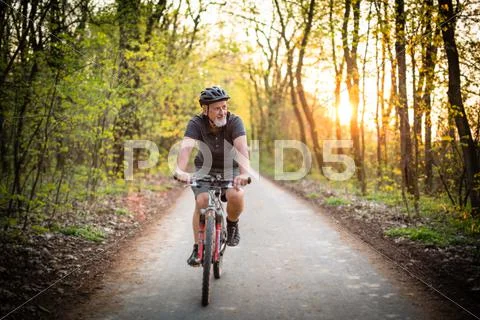 Senior man on his mountain bike outdoors (shallow DOF; color toned image) Stock Photos