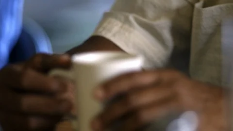 A senior man holding a coffee cup at a cafe. 库存影片 88375488