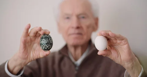 Senior Man Holding Easter Eggs in Hands Stock Footage 126791216