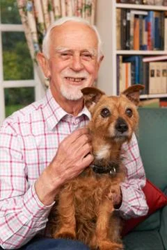Senior Man At Home With Pet Dog Stock Photos