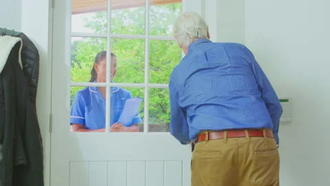 Senior Man At Home Using Walking Stick Greeting Female Nurse Or Care Worker In Stock Footage 171671901