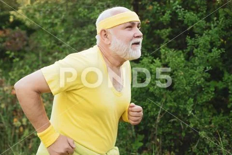 Senior man jogging in park. Like sports. Funny sporty old sportsman finished his Stock Photos