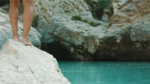 Senior Man Jumping Into The Freezing Cold Water In The Mountains from A Rock  Stock Footage 94031730