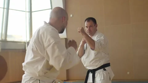 Senior man in kimono falling down after getting kick from newbie but gets up Stock Footage 138202898