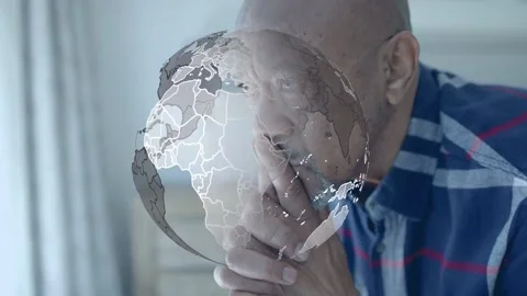 Senior man leaning, frames advancing rotating globe overlaying face and hands, Stock Footage 333145392