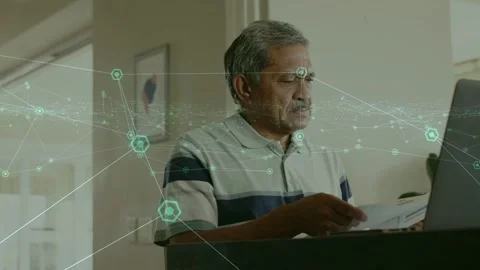 Senior man lifting papers, scanning and switching to laptop while tech overlay Stock Footage 334338103