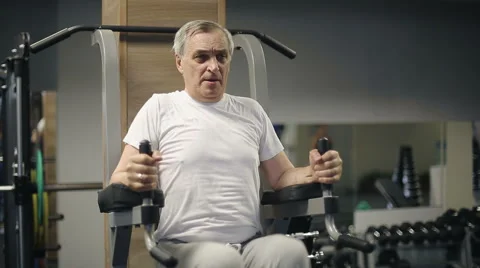 Senior man lifting weights of his body in the gym Stock Footage 52666917