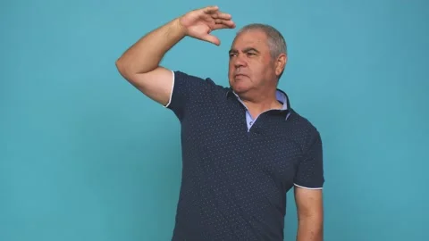 Senior man looking far away keeping hand on forehead Stock Footage 144217517
