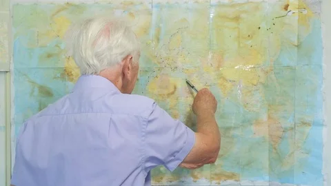 Senior man looking at an old map Video stock 89639687