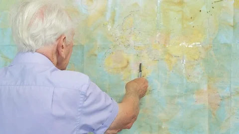 Senior man looking at an old map Video stock 89640168