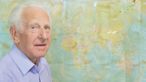 Senior man looking at an old map Video stock 89640374