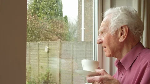 Senior man looking out of a window Stock Footage 88454425