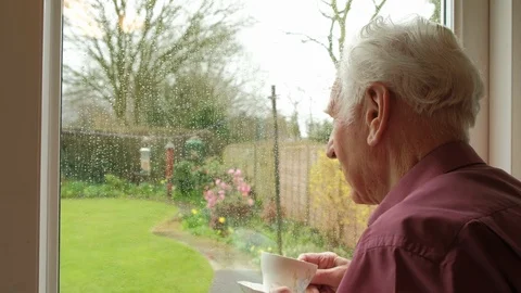 Senior man looking out of a window Stock Footage 88456215