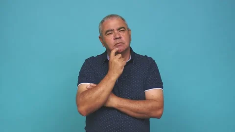 Senior man looking sideways with doubtful and skeptical expression 動画素材 144217501