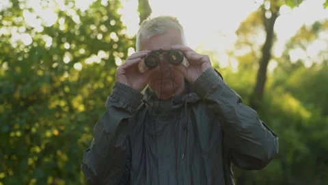 Senior man looking through binoculars. Stock Footage 138503388