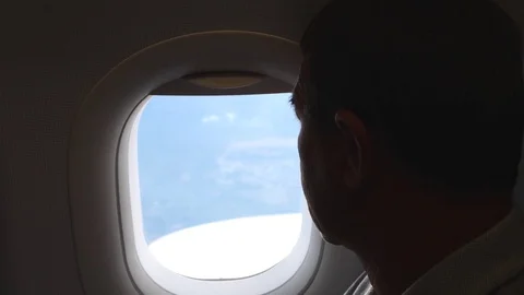 Senior Man Looking At Window In Airplane Flying On Vacation Stock Footage 84985310