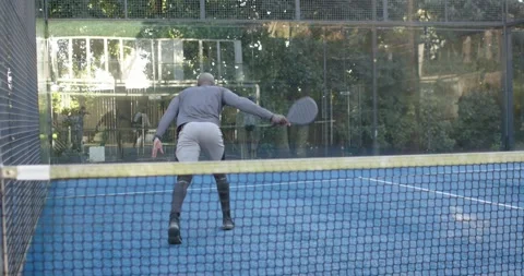 Senior man lunging for fast ball, sliding, running smash with paddle to score, Stock Footage 342033462