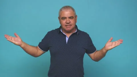 Senior man makes scale with arms, feels happy and confident Stock Footage 144217812