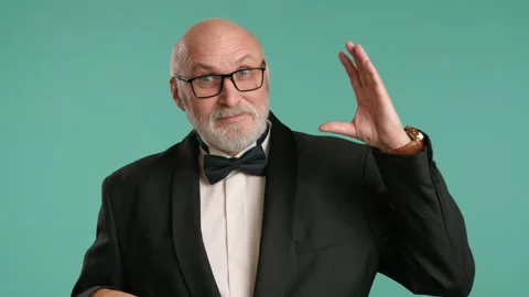Senior Man Making Hand Gesture Signifying Lots of Talking on Teal Background Stock Footage 267190287