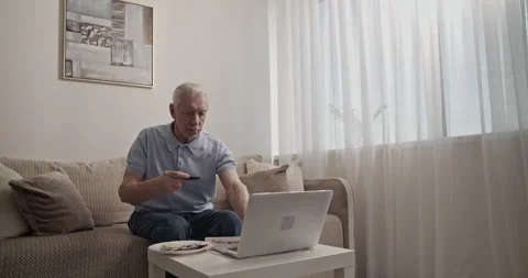 Senior man making online purchases Stock Footage 196237752