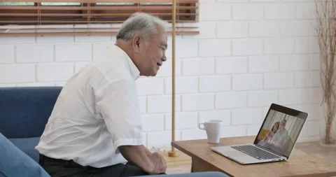 Senior man making video call to friends with laptop at home. Stock Footage 153250215