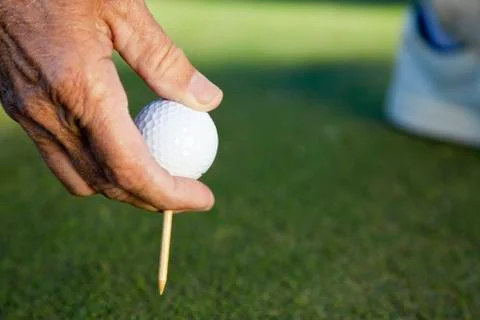 Senior man male hand golf ball & tee Stock Photos