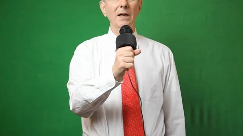 Senior Man with Microphone Delivering Speech Green Screen Stock Footage 108044648