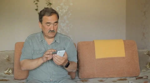 Senior man with a mustache touching the mobile phone. He wrote in the social Stock Footage 65375854