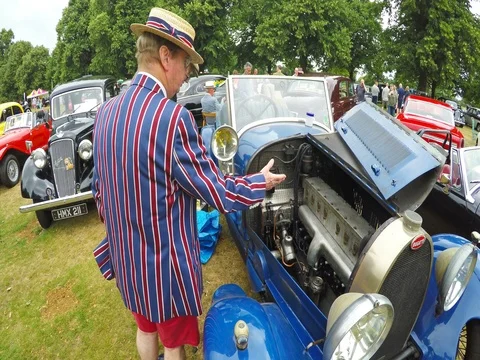 Senior man in an old fashioned clothes trying to sell a retro car on an auction Stock Footage 80066579
