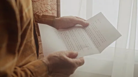 Senior Man Opening Envelope and Reading Letter by Window Stock Footage 337580236