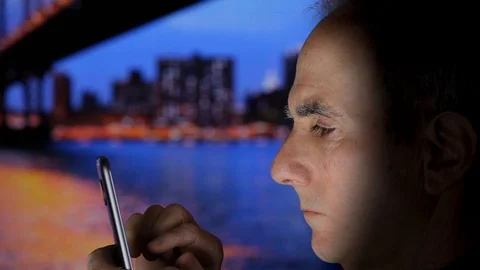 Senior Man Outdoors Using Cell Phone in Evening Stock-Footage 104557300