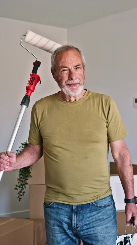 Senior man with paint roller renovating new home Stock Footage 345821793