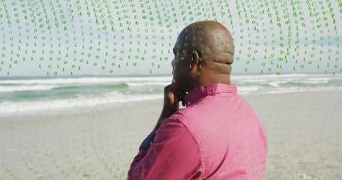 Senior man pink shirt musing on shore, panning revealing face while binary Stock Footage 329899241